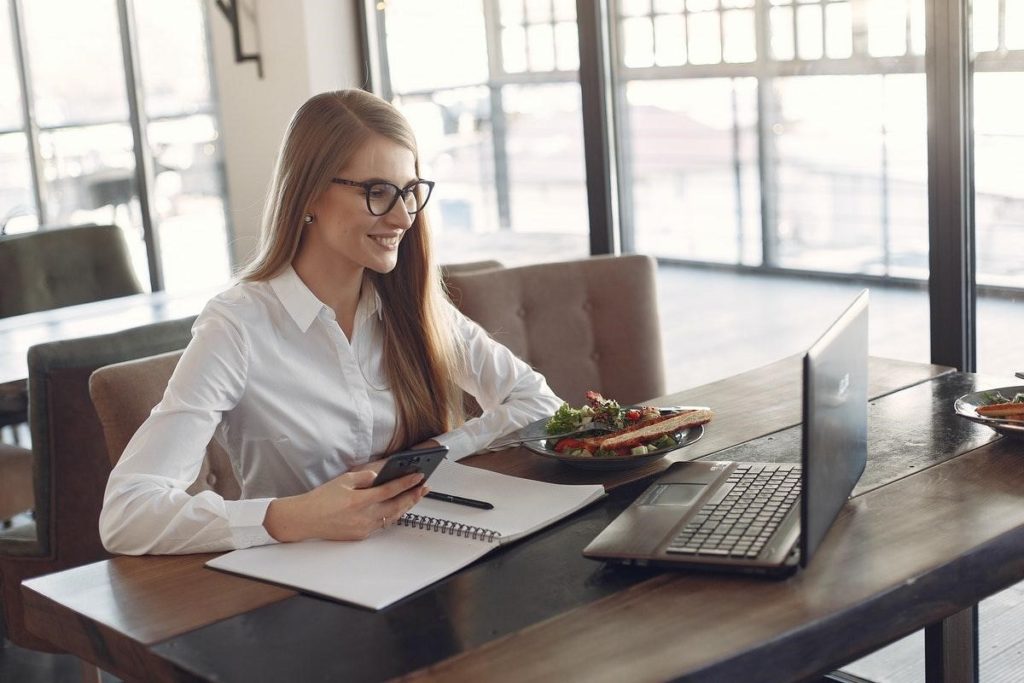 Woman sitting at desk with computer working remotely